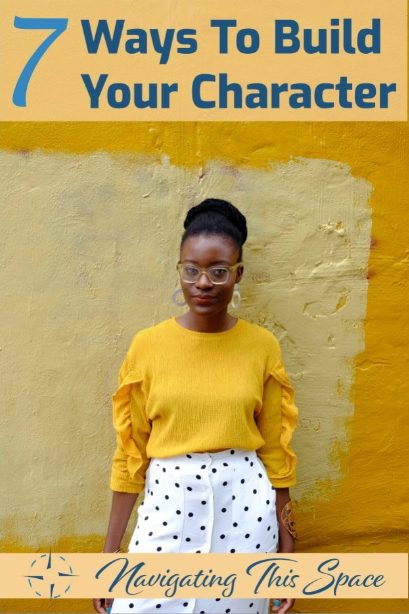 African model poses in a yellow shirt with white skirt polka dots