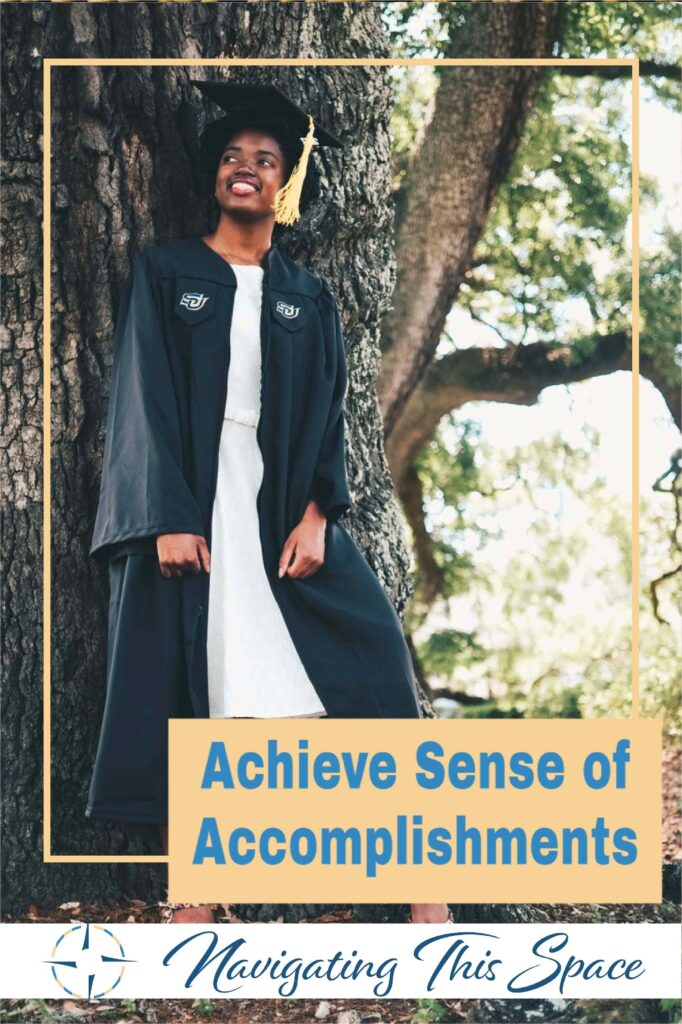 Woman wearing a graduate cap and gown smiles having a sense of accomplishments