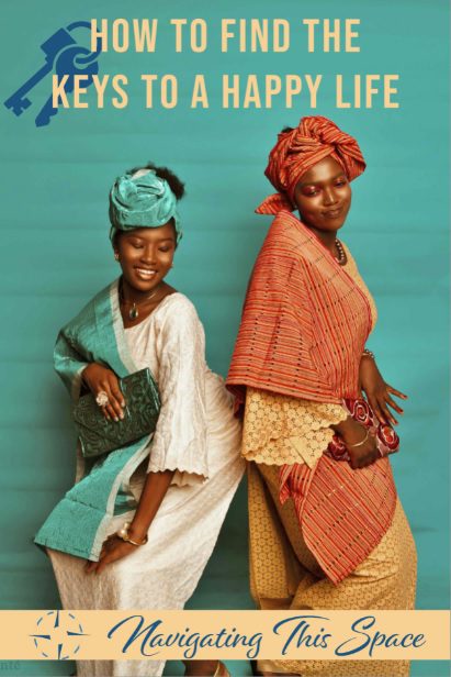 Two African women in their traditional dress wearing turbans smiling