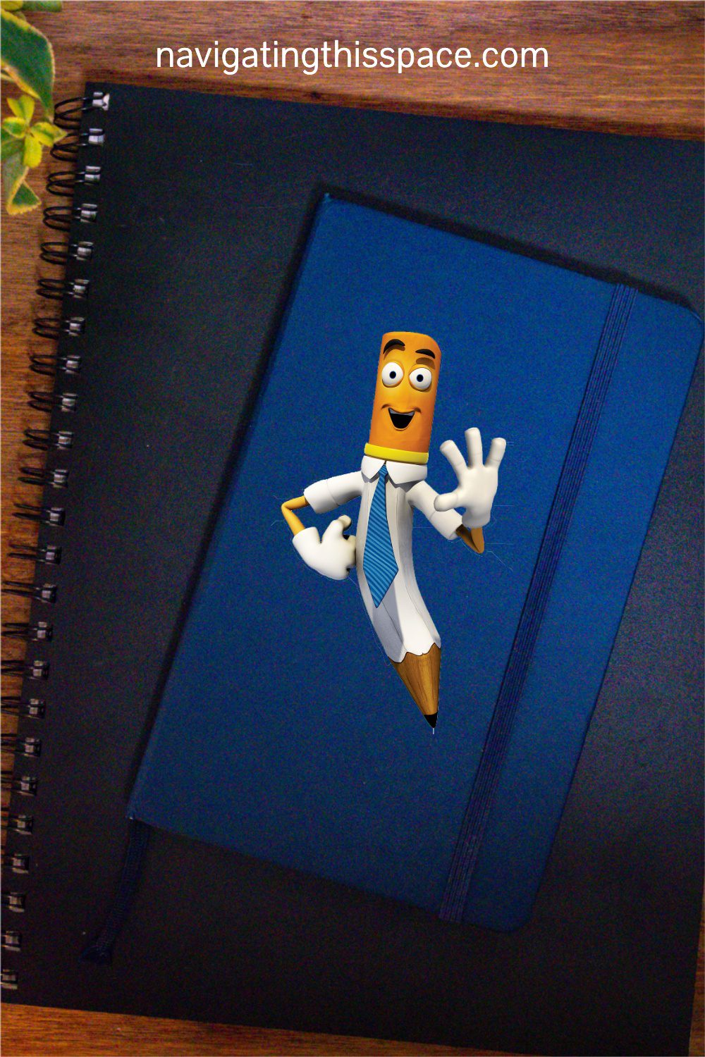 a happy pen character on top of a blue journal, and a black sketchbook