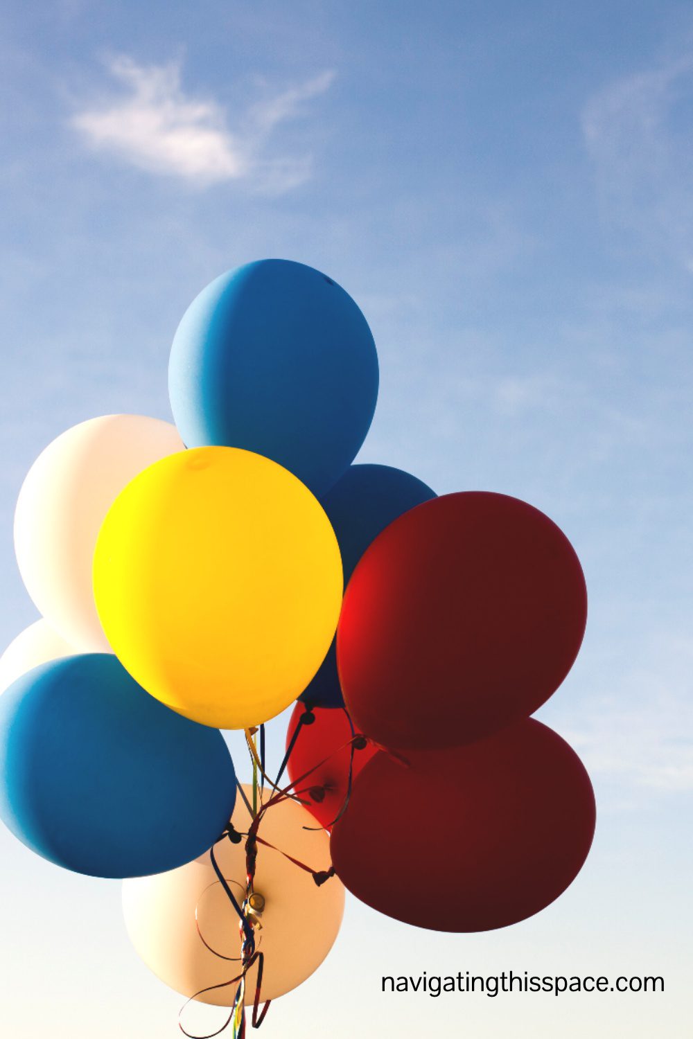 red, yellow, blue, and white balloons in the sky
