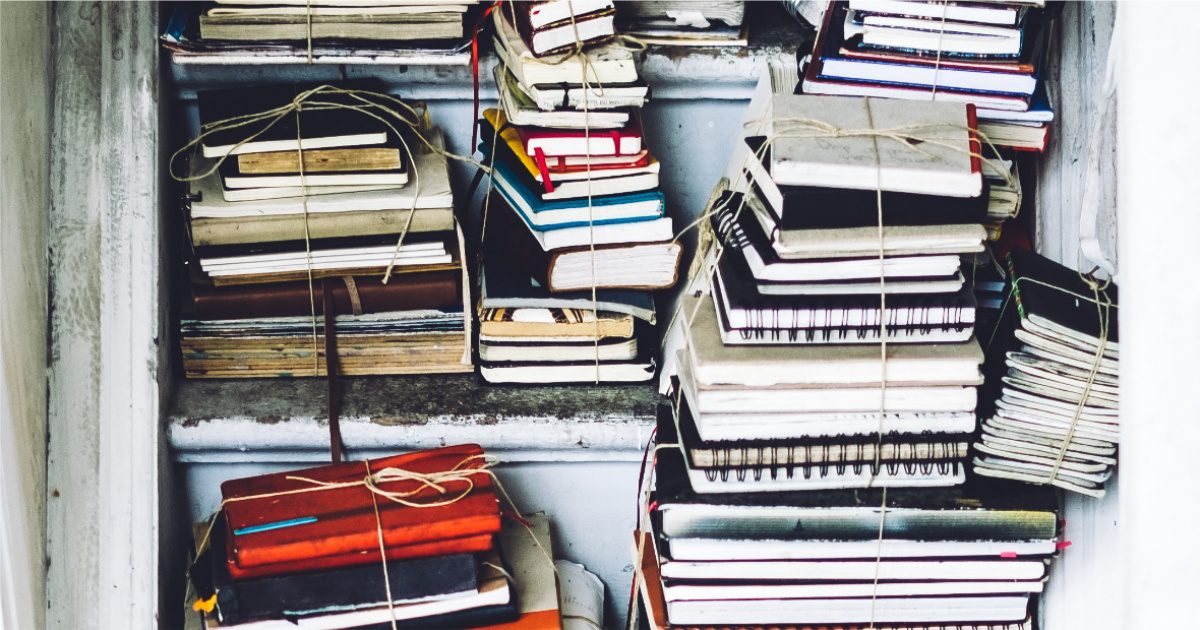 stacks of journals tied together in a closet