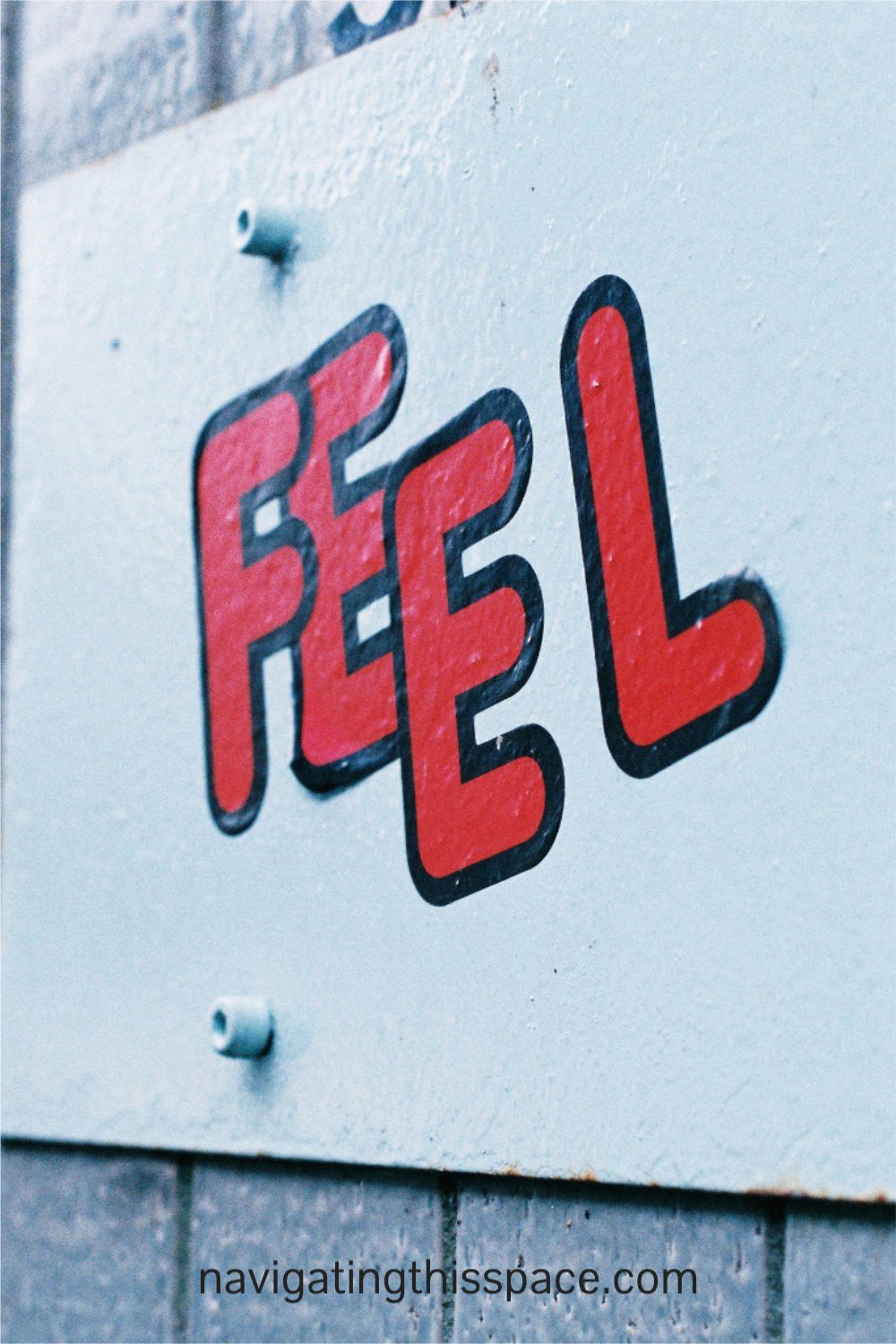 the word feel painted on a wall meaning to use your feeling when writing