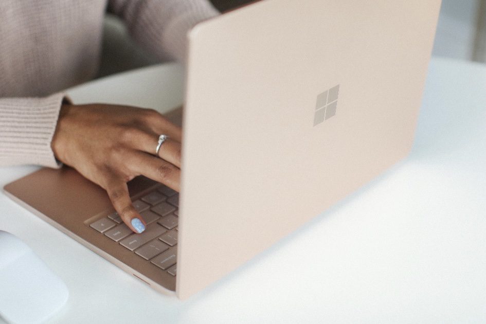 woman's hand on a laptop searching for travel safety tips and requirements