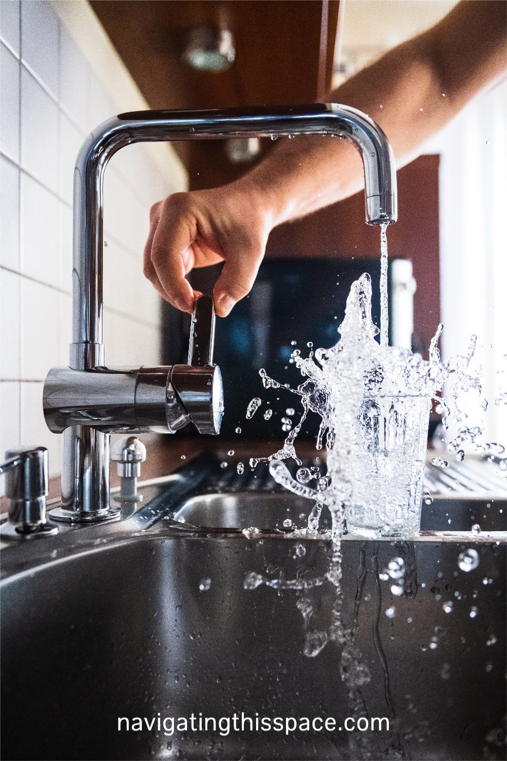 water splashing in a drinking glass from a fountain