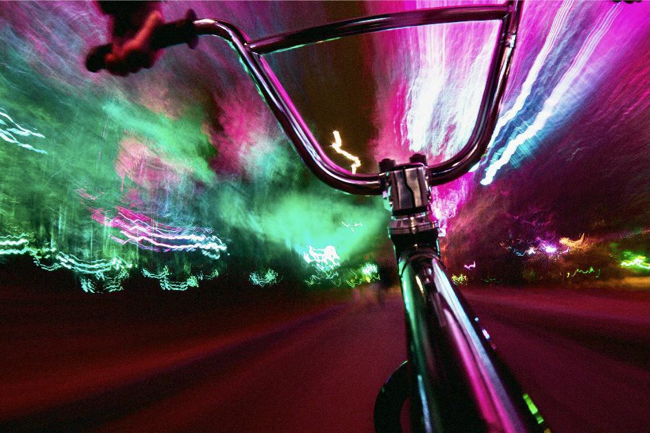 bicycle riding into purple and green lights representing a visual abstraction for what is visualization