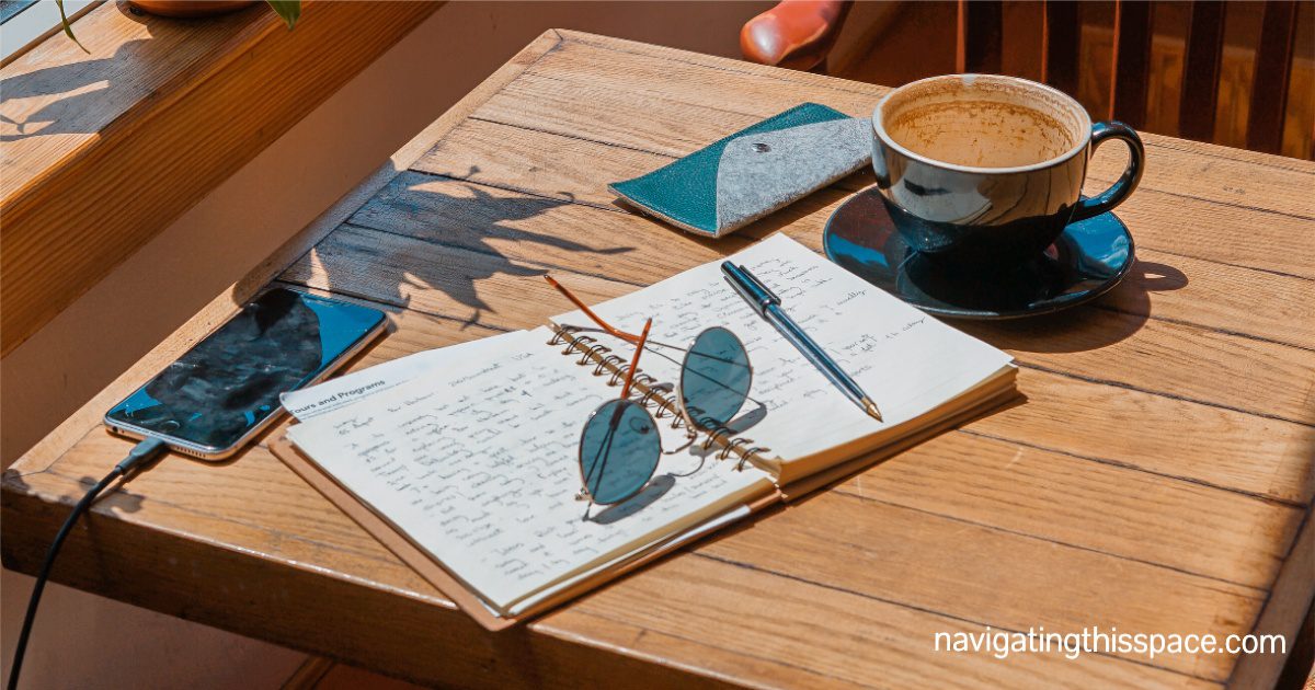 open notebook on a wooden table with answers to journal prompts for self-reflection