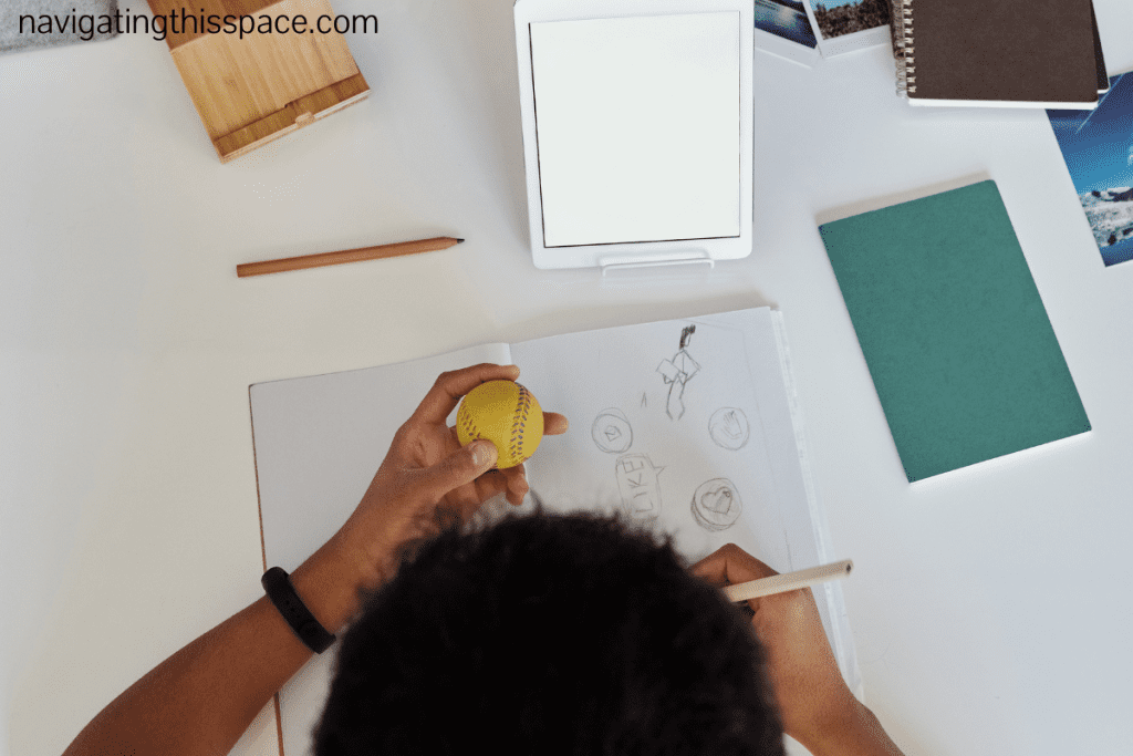 An image of a person drawing on a white paper