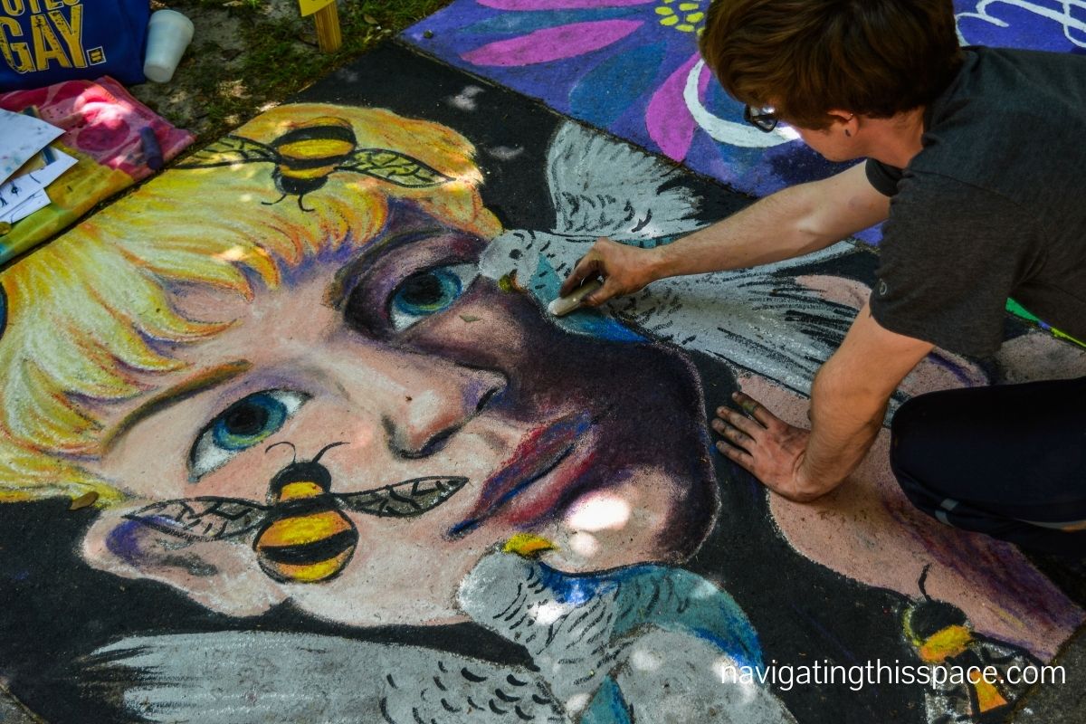 a person drawing a mural on the ground