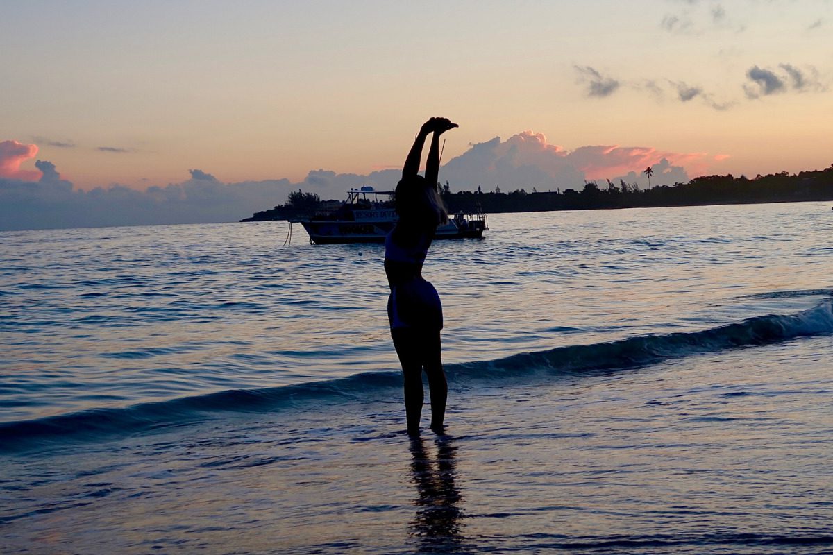 women standing on beach of Caribbean island