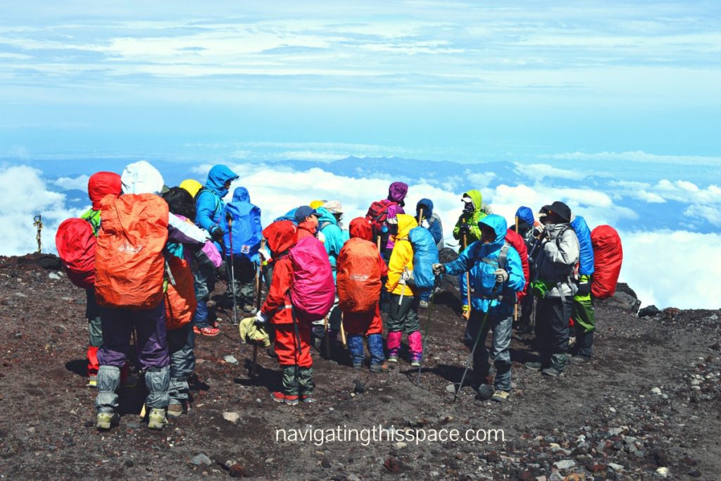 people in colorful dresses on top of mountain Fuji